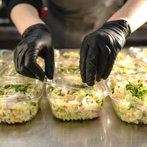 Healthy food delivery. organic healthy salad in a disposable bowl. Clean food concept, healthy food, chef covers lunch boxes. copy space.
